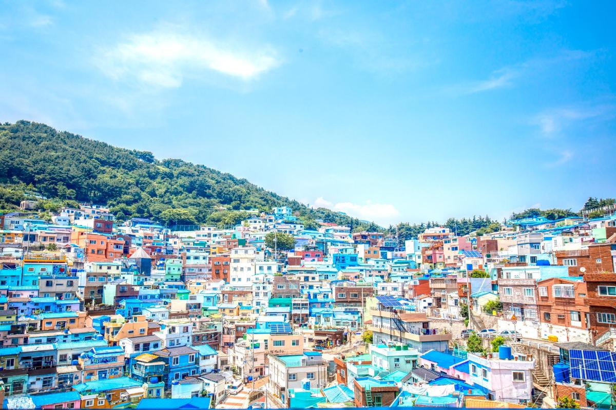 a city with blue and white buildings on a hill