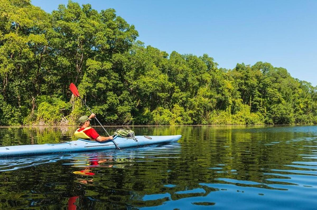 a woman is paddling a kayak on a lake