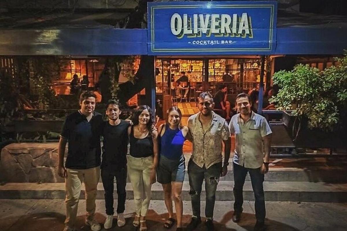 a group of people standing in front of a restaurant