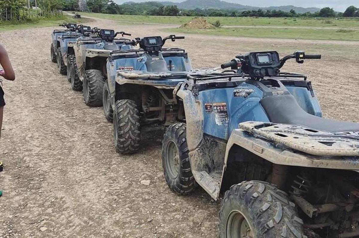 a row of atvs parked on a dirt road