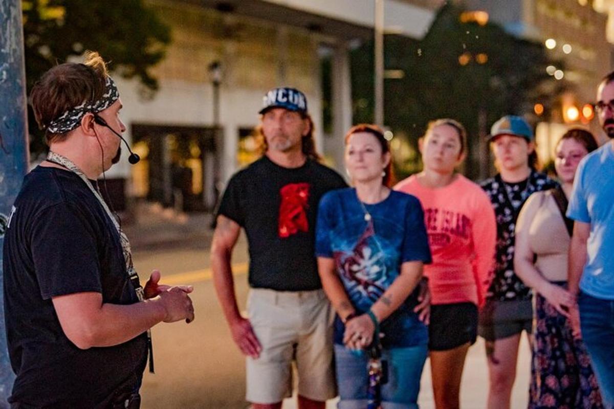 a man talking to a group of people on the street