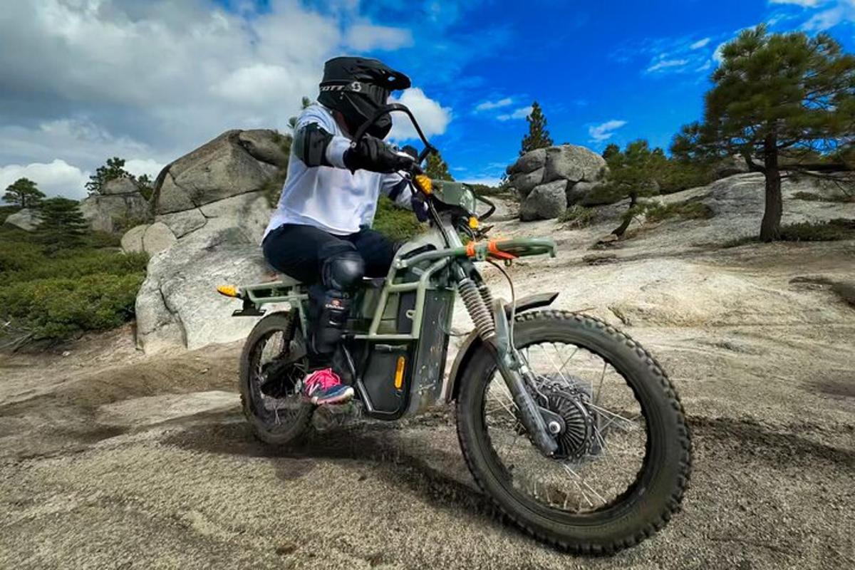 a man riding a motorcycle on a dirt road