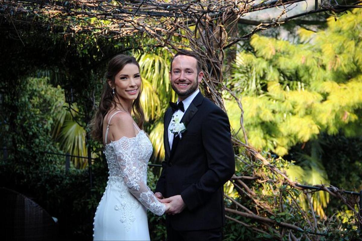 a bride and groom standing next to each other