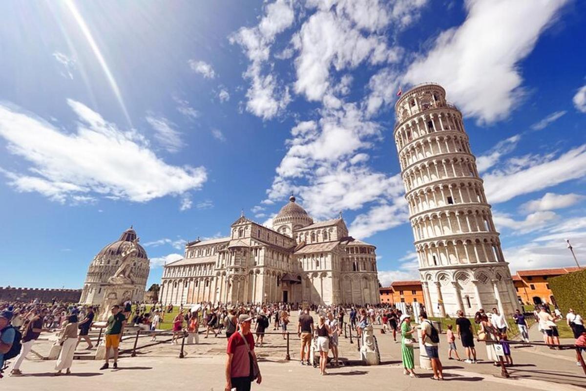 a group of people standing in front of the leaning tower