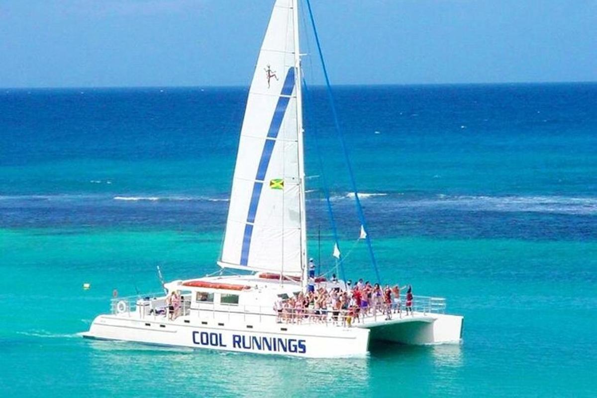 a group of people on a sail boat in the ocean