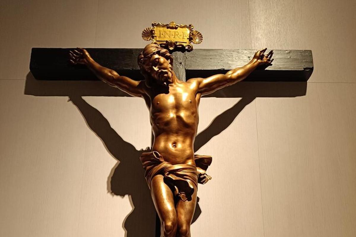 a statue of a builder on a cross