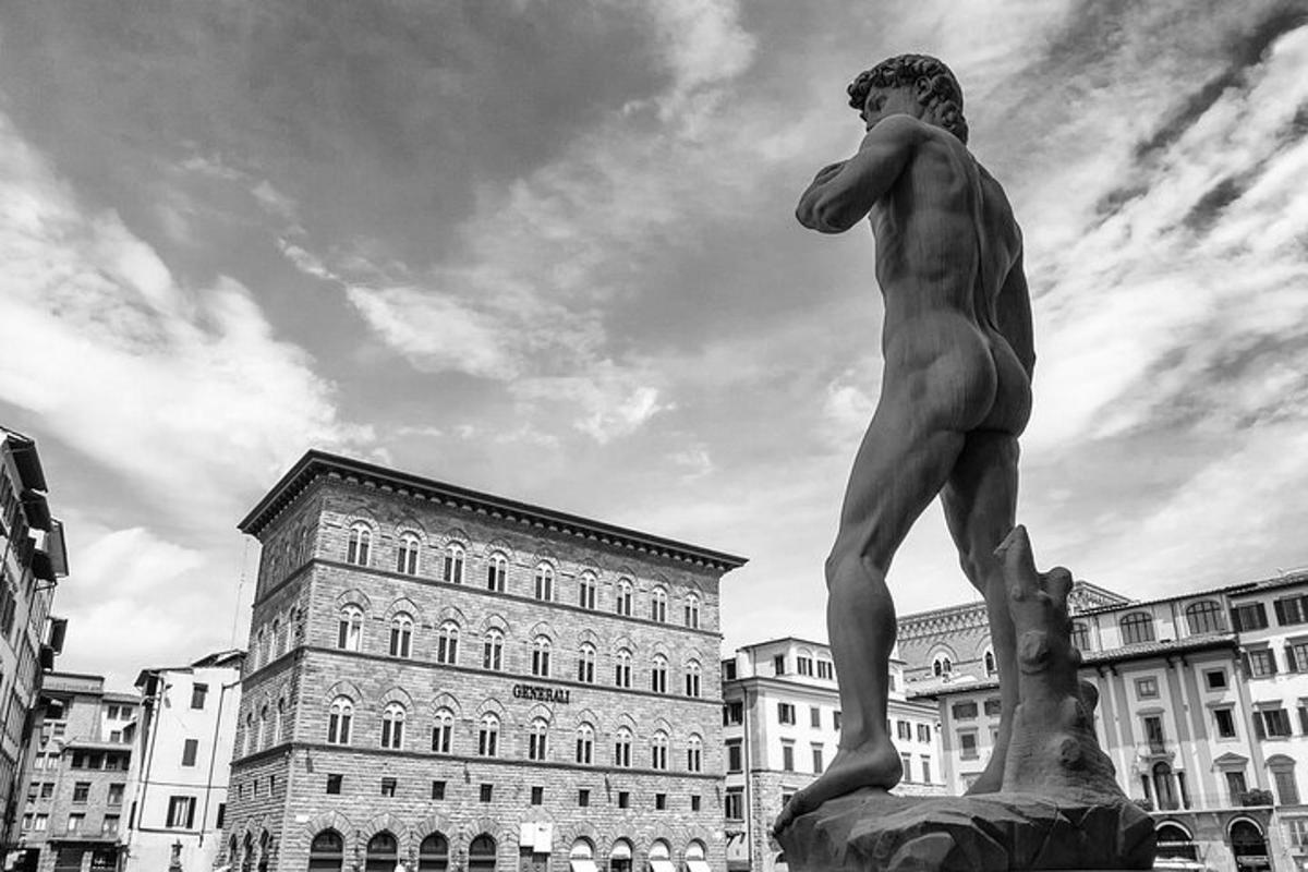 a statue in the middle of a city with buildings