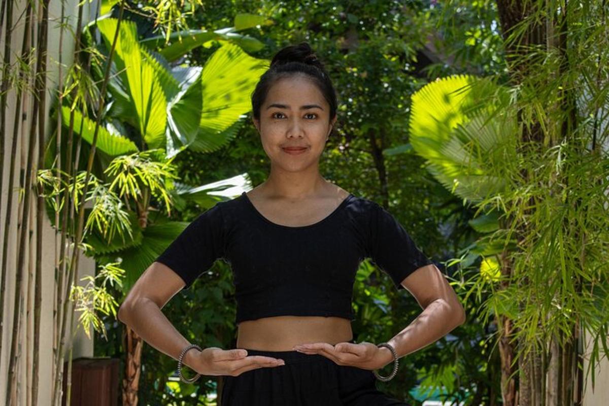 a woman is standing with her arms crossed