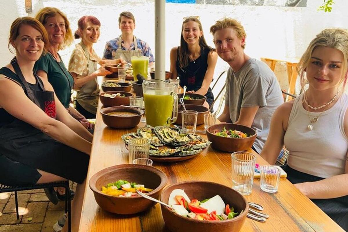a group of people sitting around a table with food