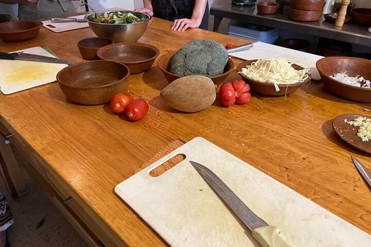 a wooden table with bowls and vegetables on it