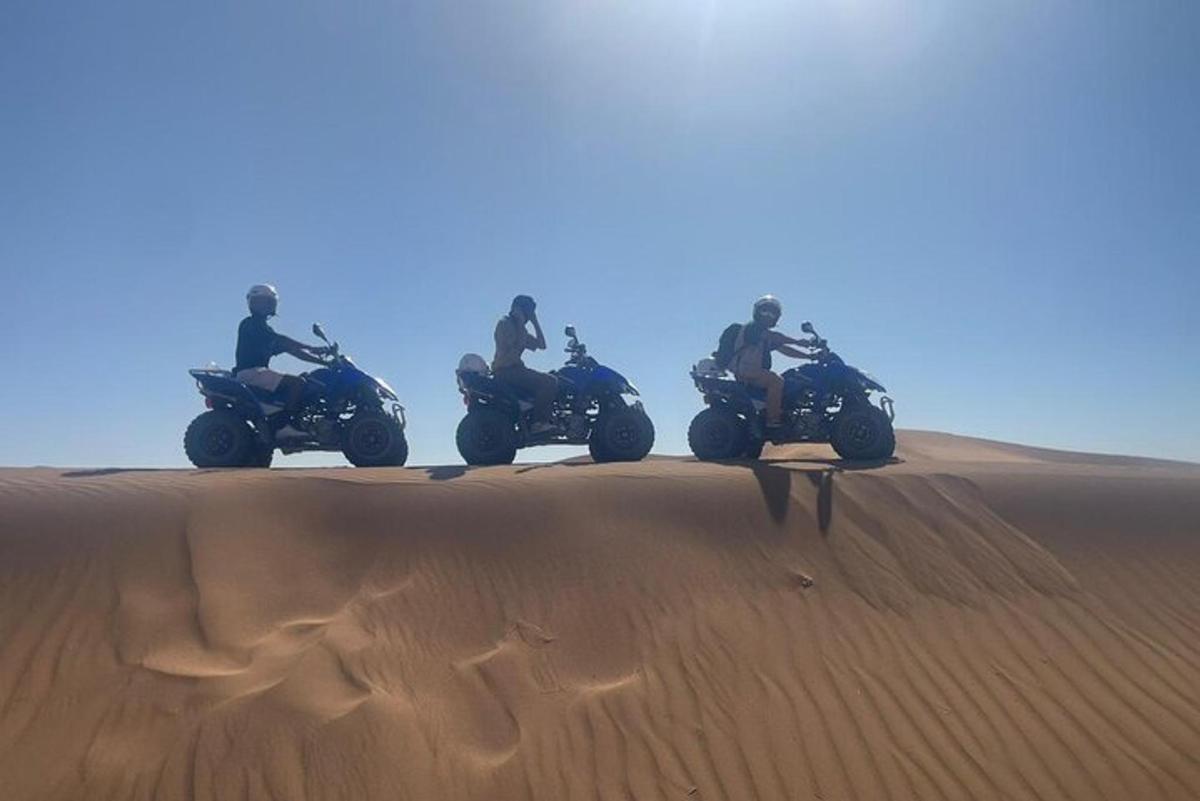 a group of people riding motorcycles in the desert
