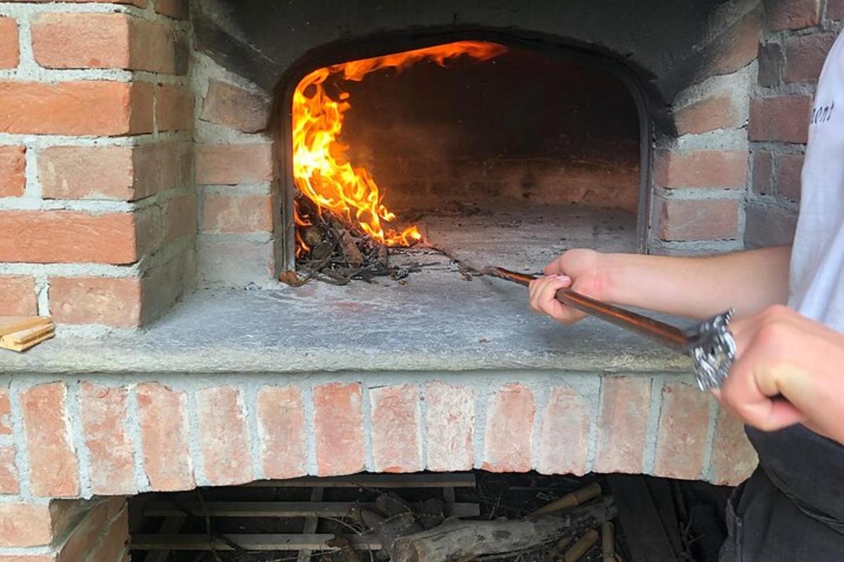 a person is putting something into a brick oven