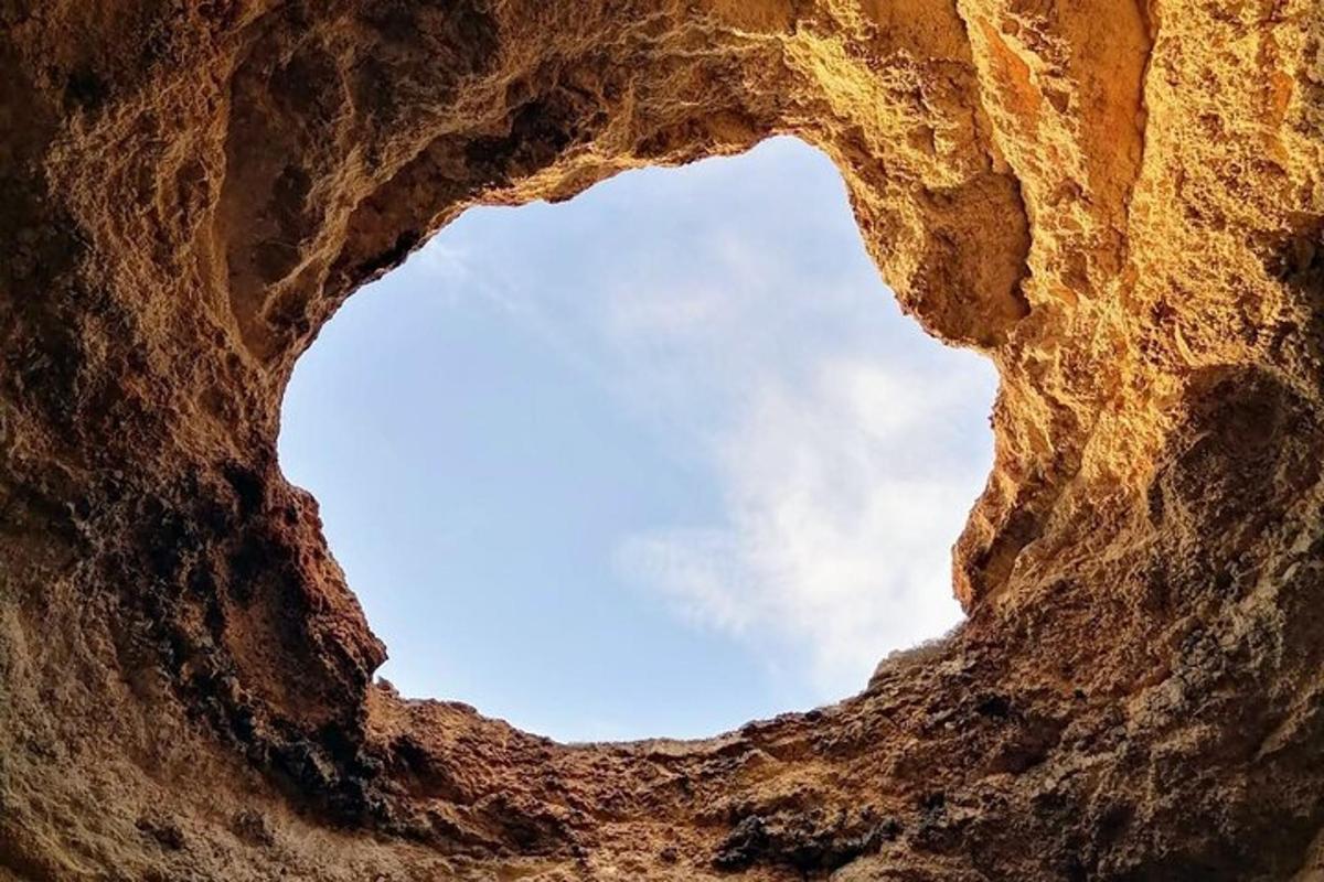 a view of the sky through a rock formation