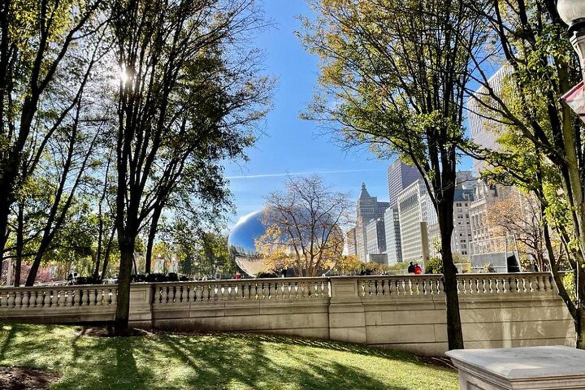 a bridge in a park with trees and buildings