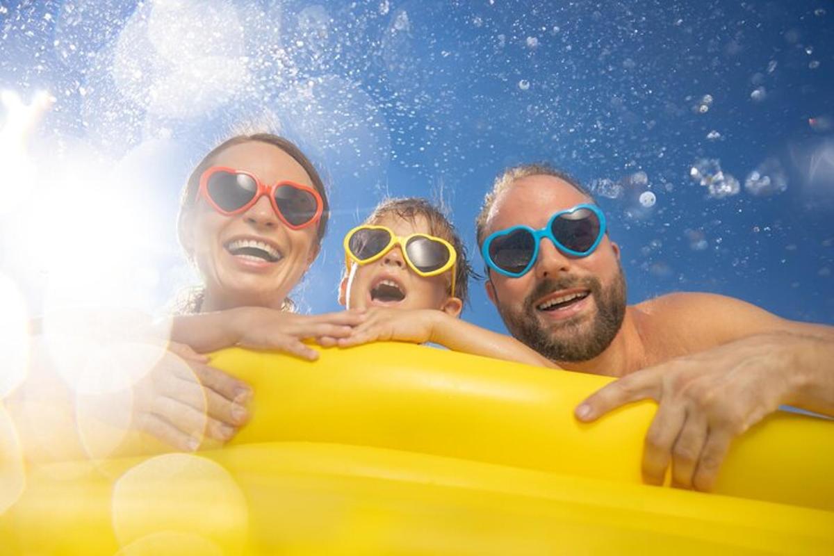 a group of people in the water with a yellow raft