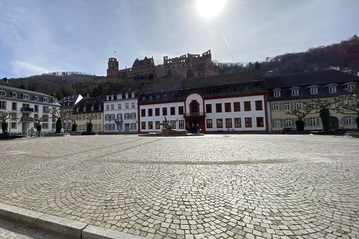 a large brick courtyard with a castle in the background