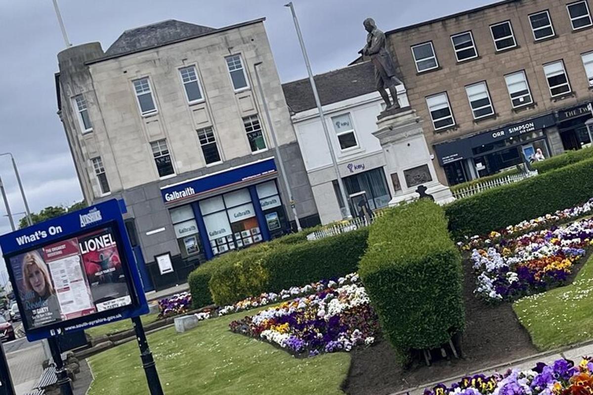 a street with flowers in front of buildings