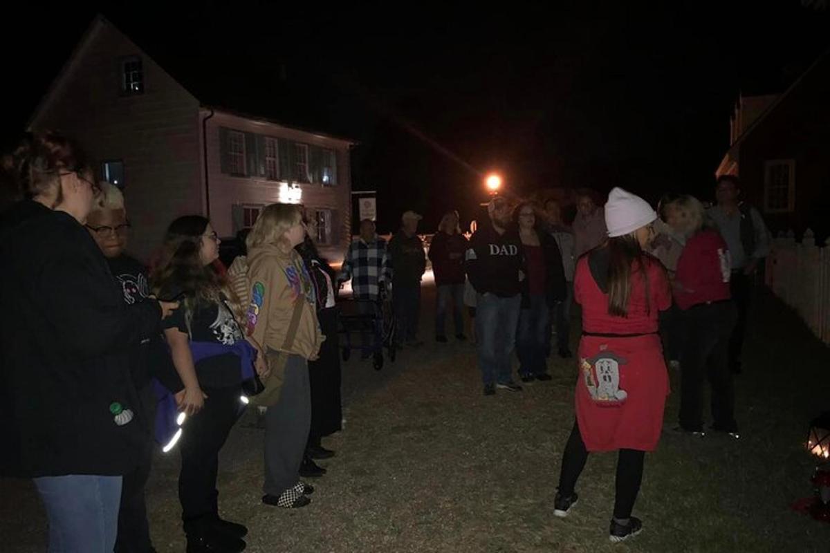 a crowd of people standing around at night