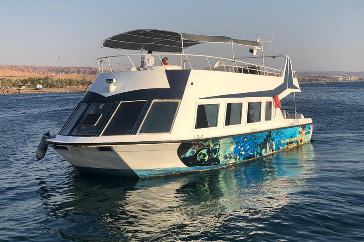 a boat in the water with two people on it