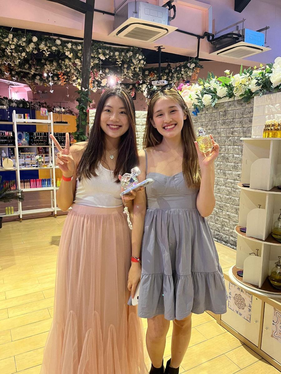 ドレスを着た二人の女の子が店で写真を撮るためにポーズをとっている