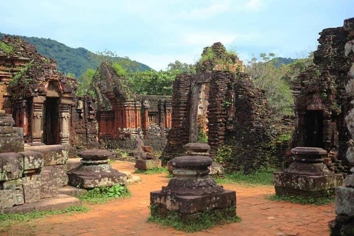 an ancient building with stone pillars in a field