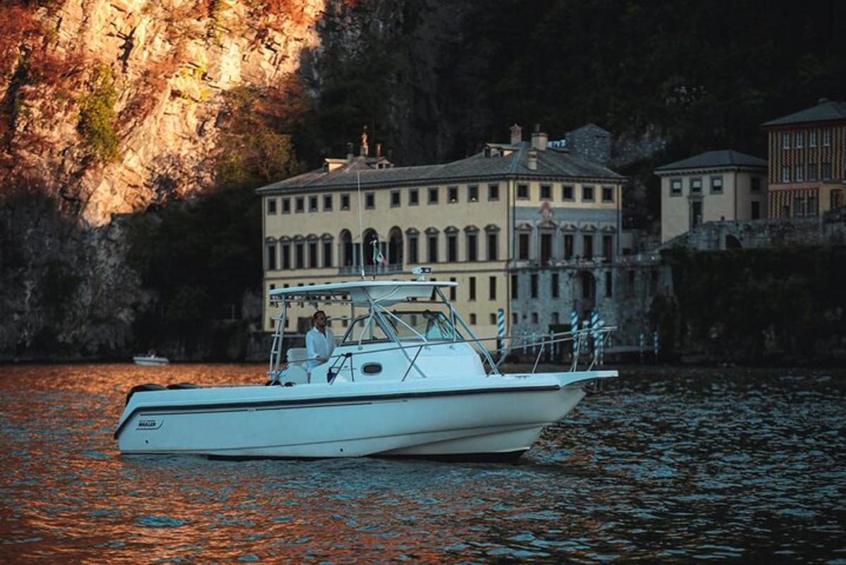 a white boat in the water in front of a building