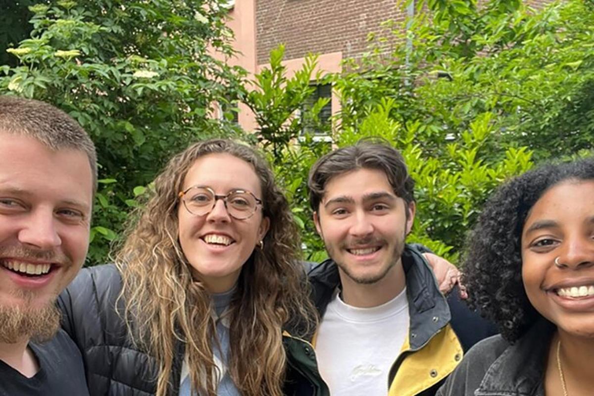 a group of four people posing for a picture