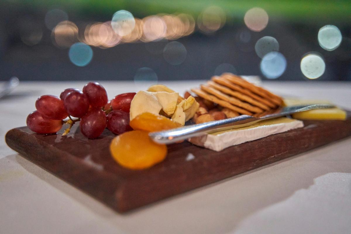 a plate of food with fruit and crackers on a table
