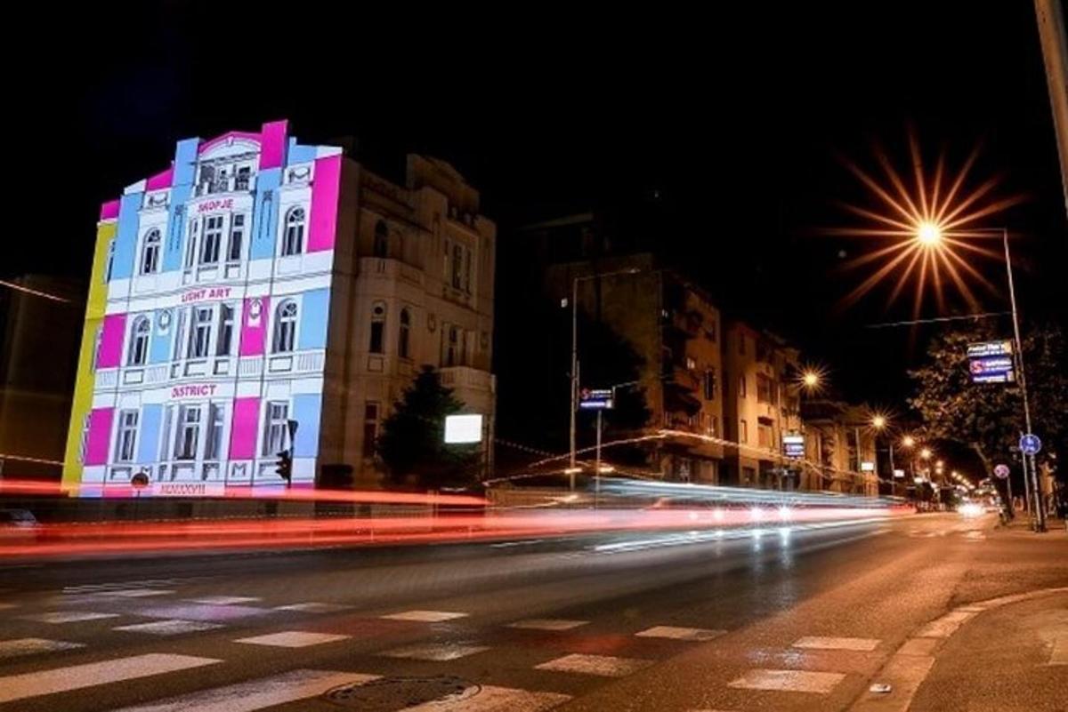 a lit up building on a city street at night