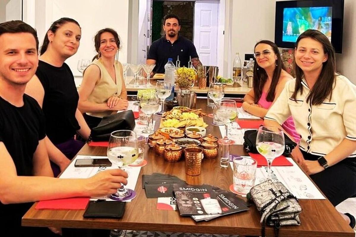 a group of people sitting around a table with wine glasses