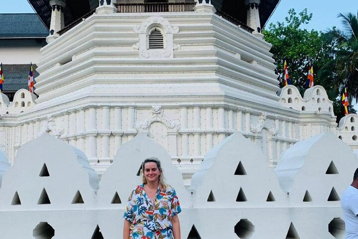 a woman standing in front of a white building