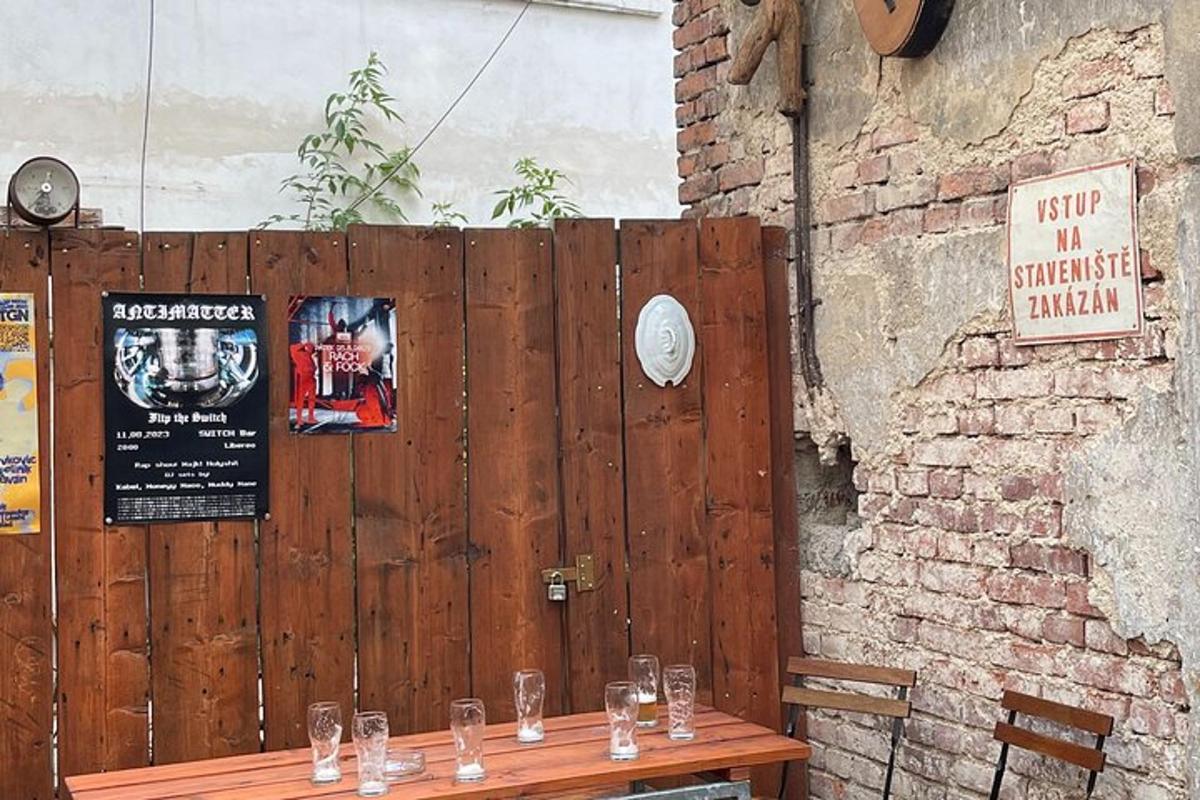 a wooden table with glasses on it next to a wall
