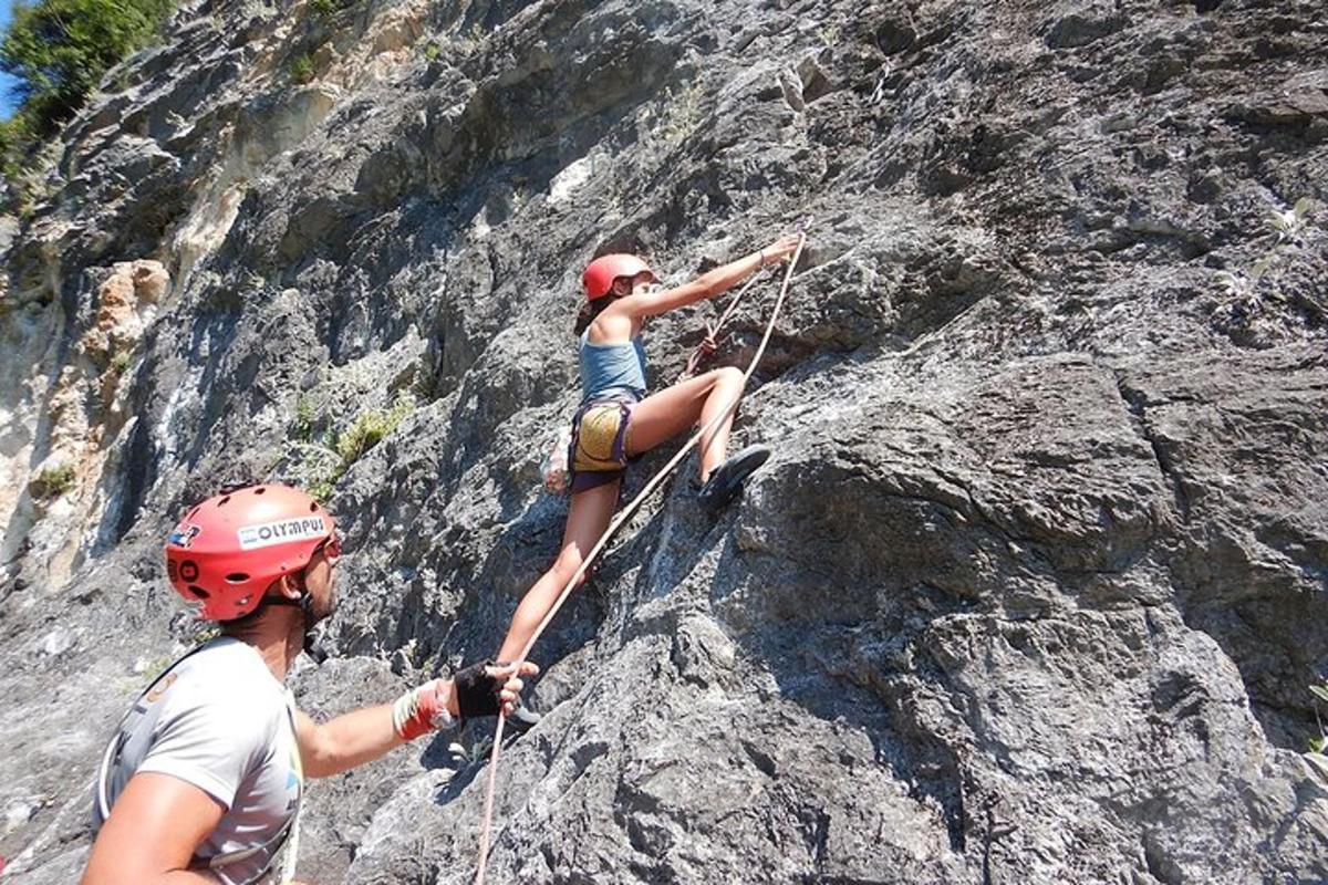 a man and a woman climbing on a mountain