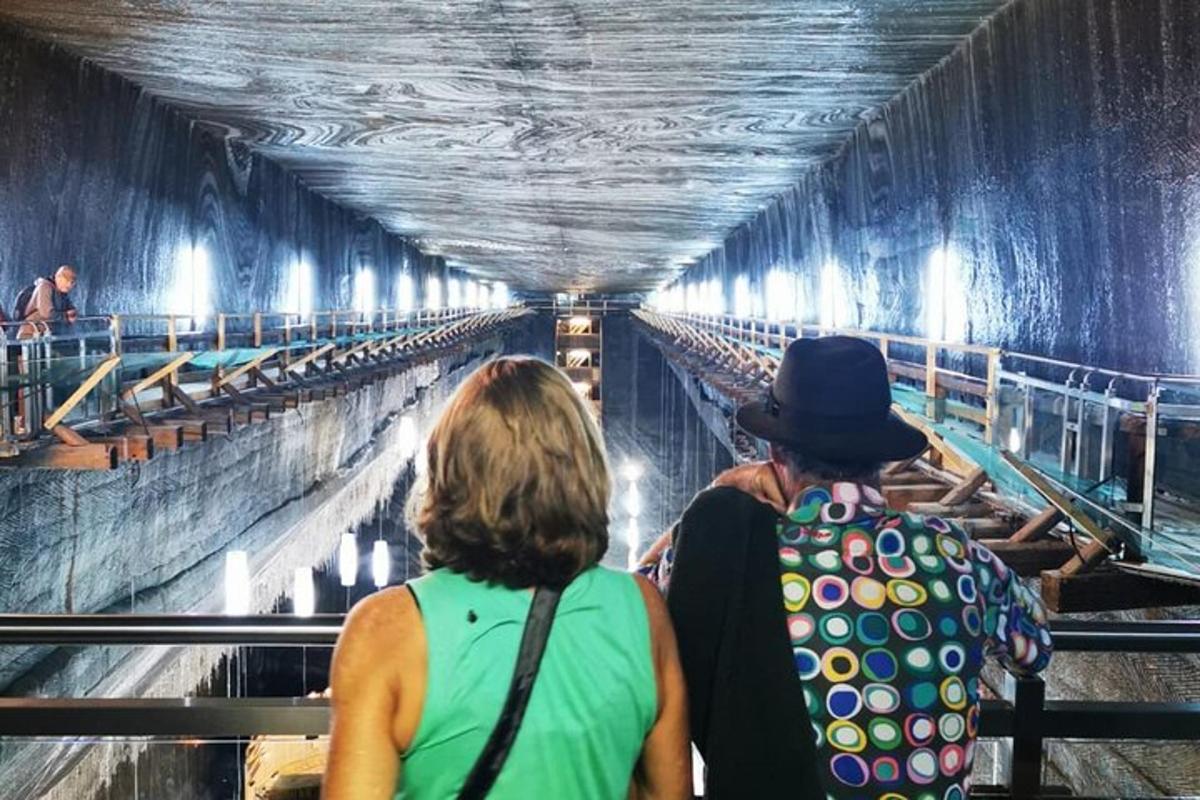 two people walking through a water tunnel