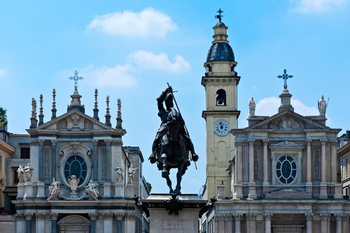 a building with a statue in front of a clock tower
