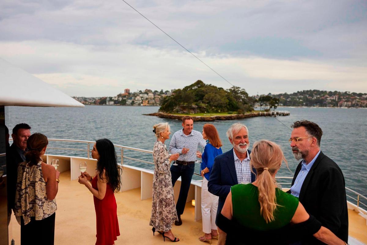 a group of people standing on the deck of a boat
