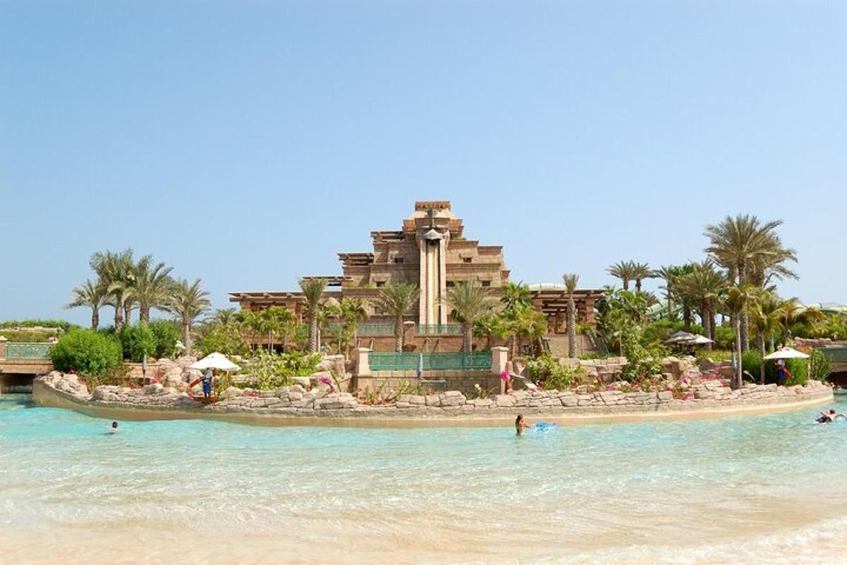 a resort on the beach with people in the water