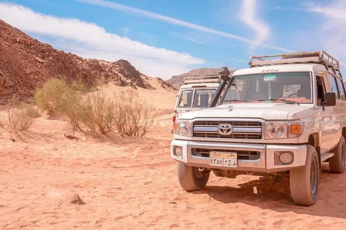 a white truck parked in the desert