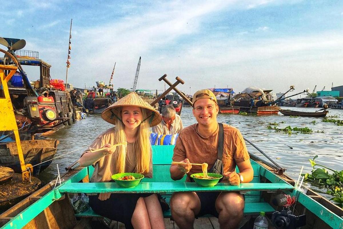 a man and woman sitting in a boat on the water