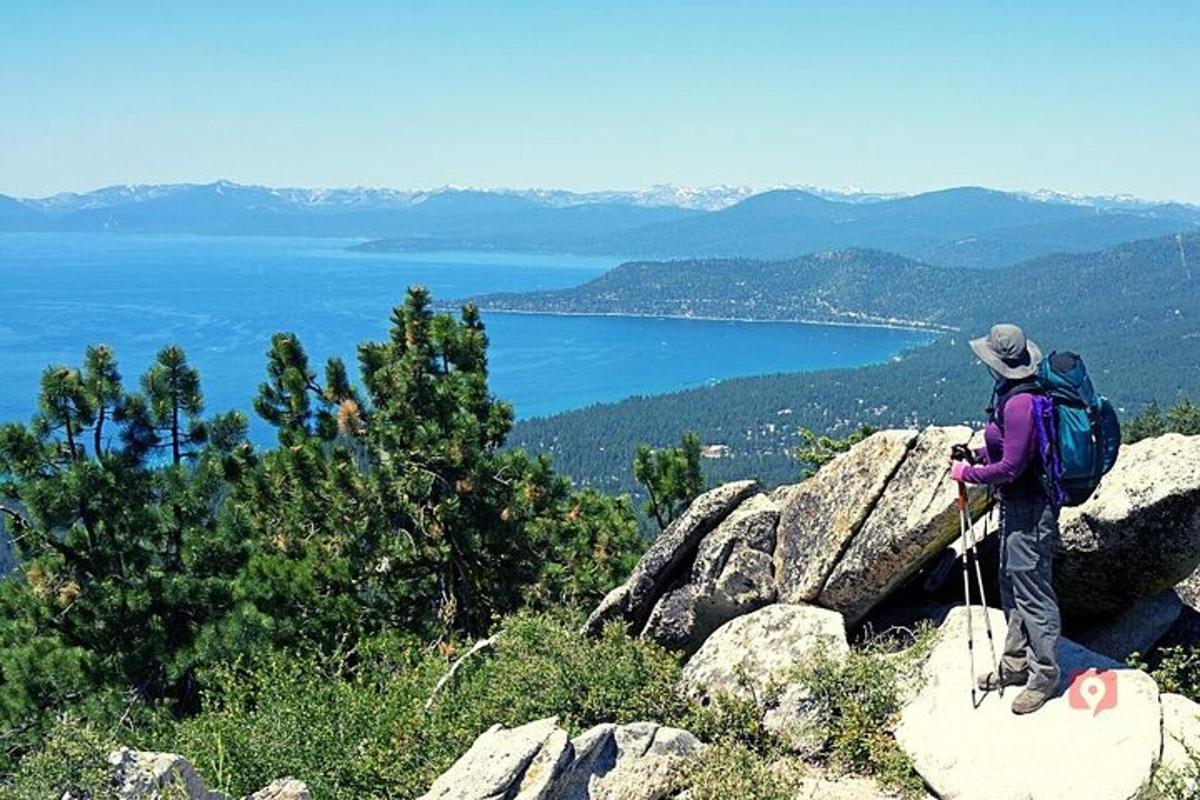 a person with a backpack standing on top of a mountain