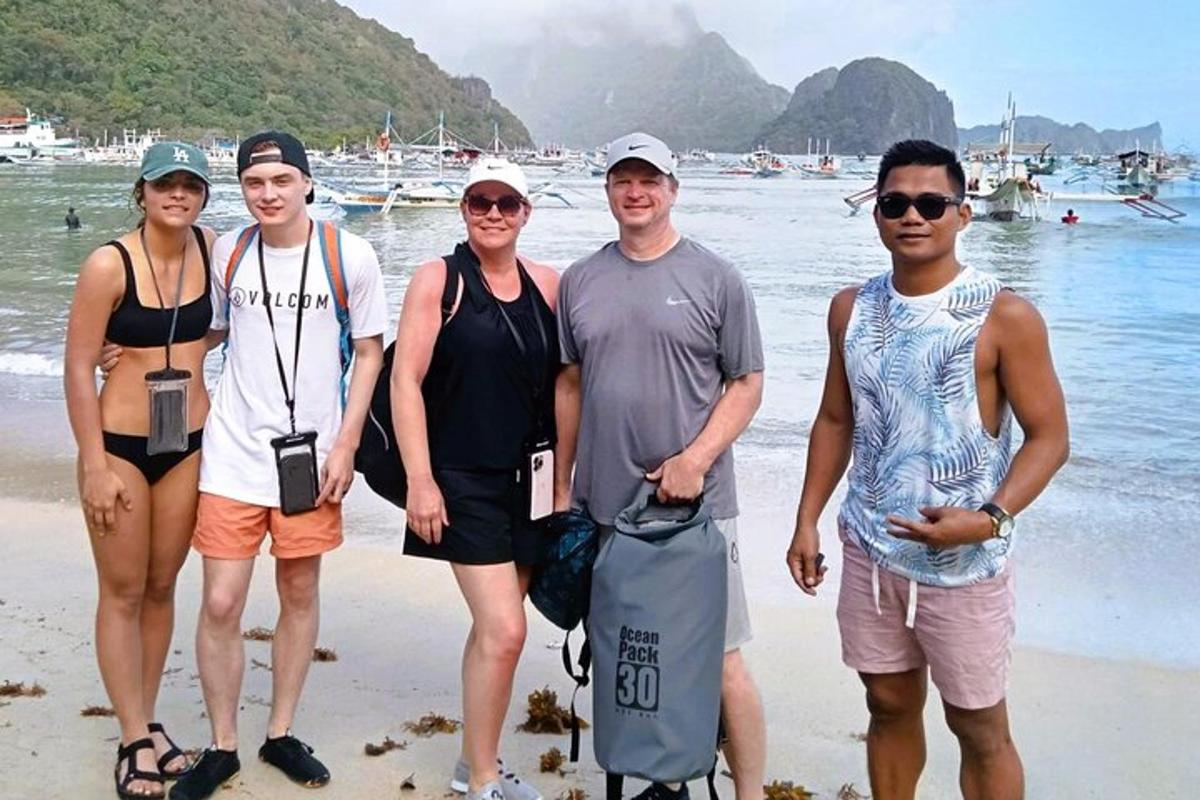 a group of people standing on the beach