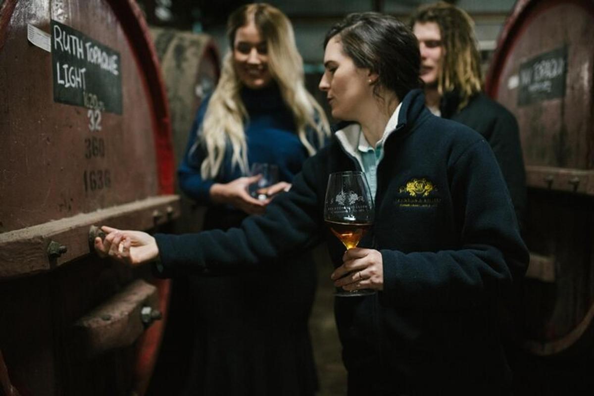 a woman is holding a glass of wine