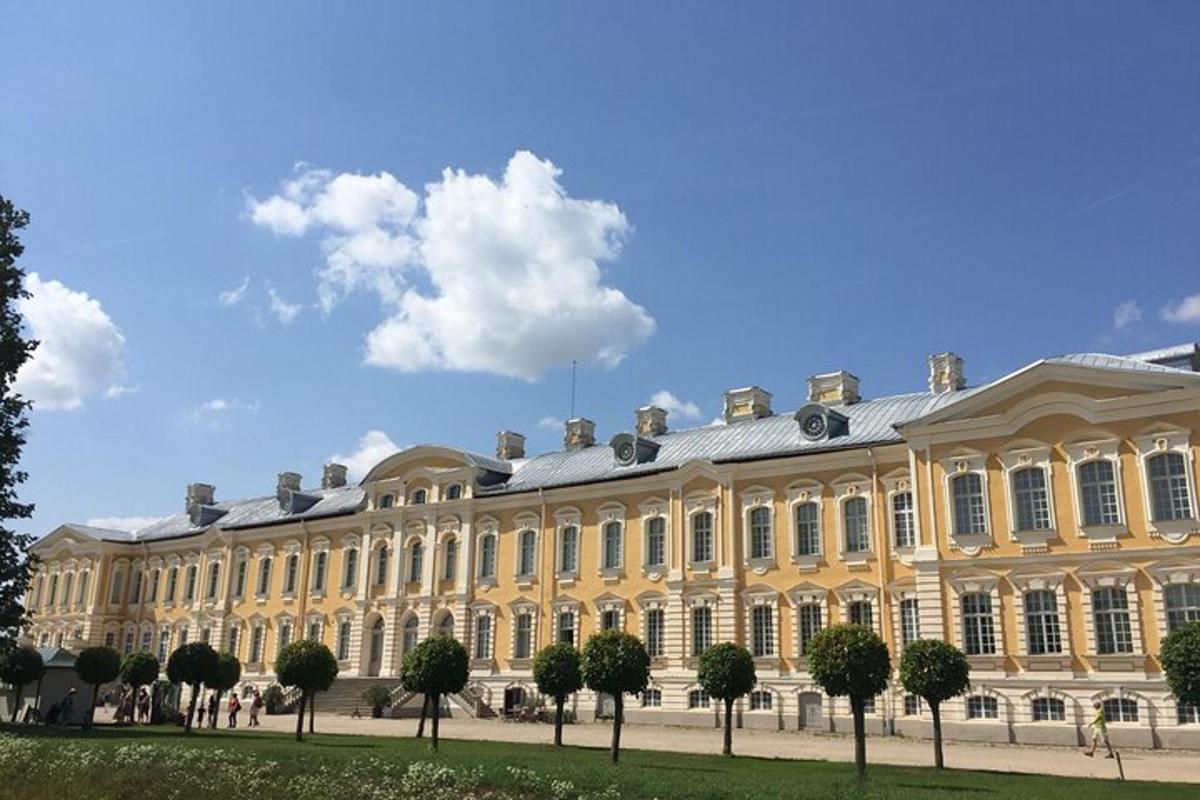 a large yellow building with trees in front of it