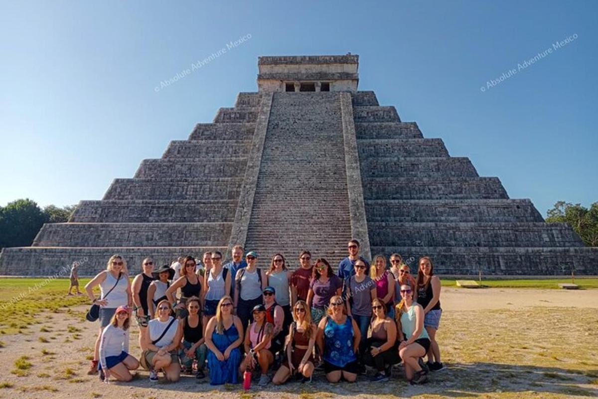 a group of people posing in front of a pyramid