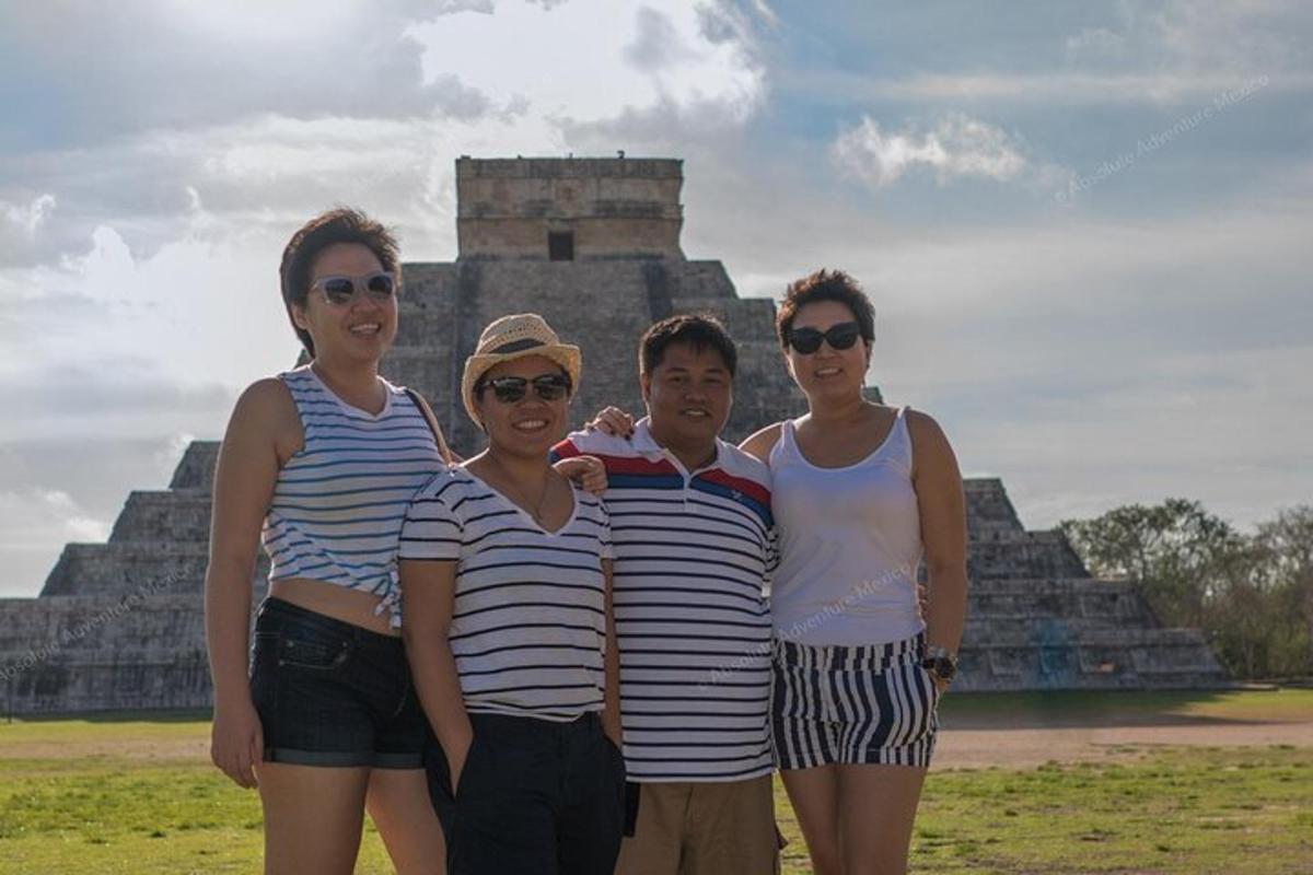 a group of people standing in front of a pyramid