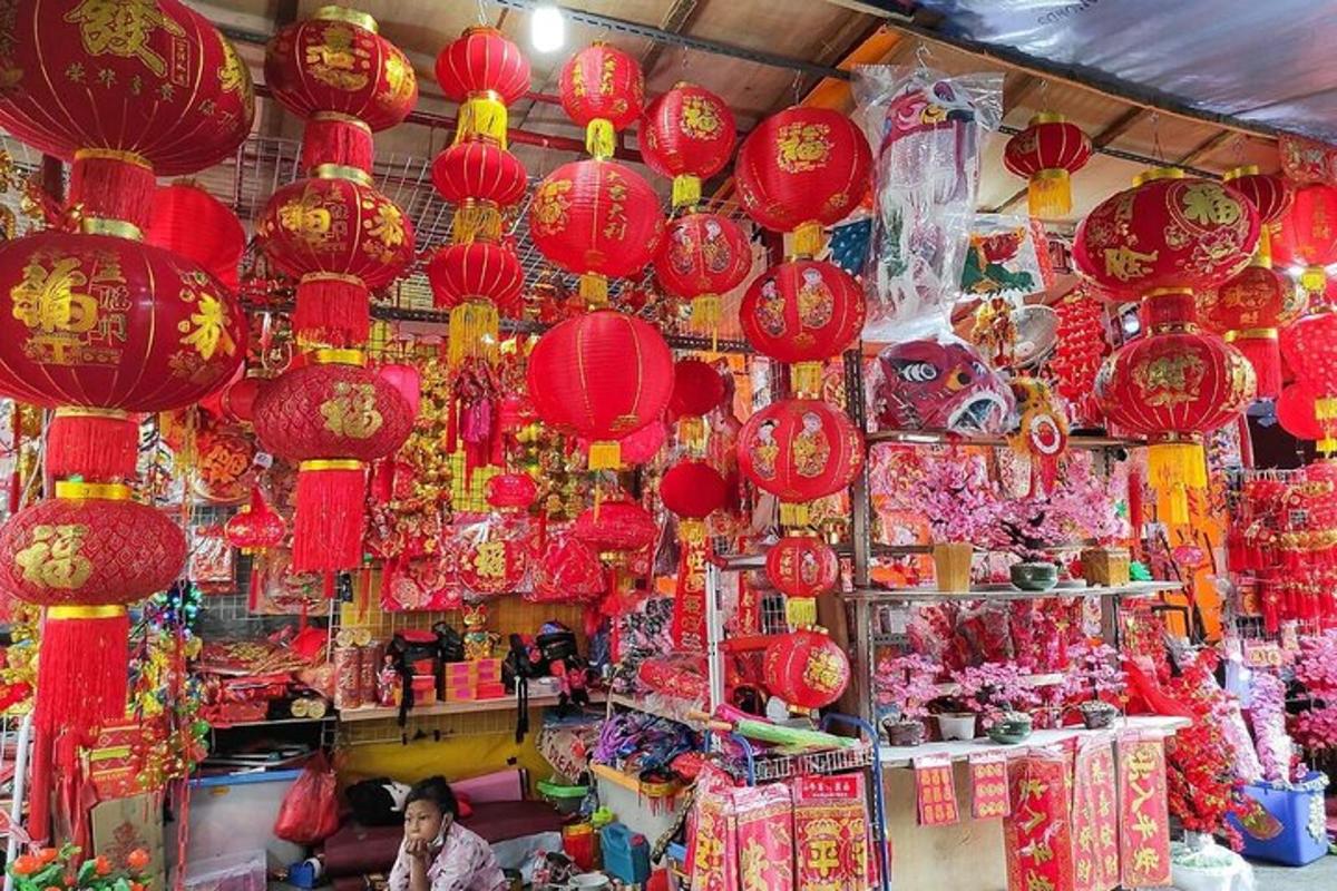 a store with red lanterns and other decorations in a market
