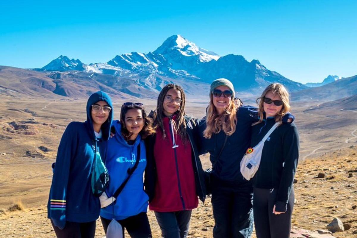 a group of women standing in front of a mountain