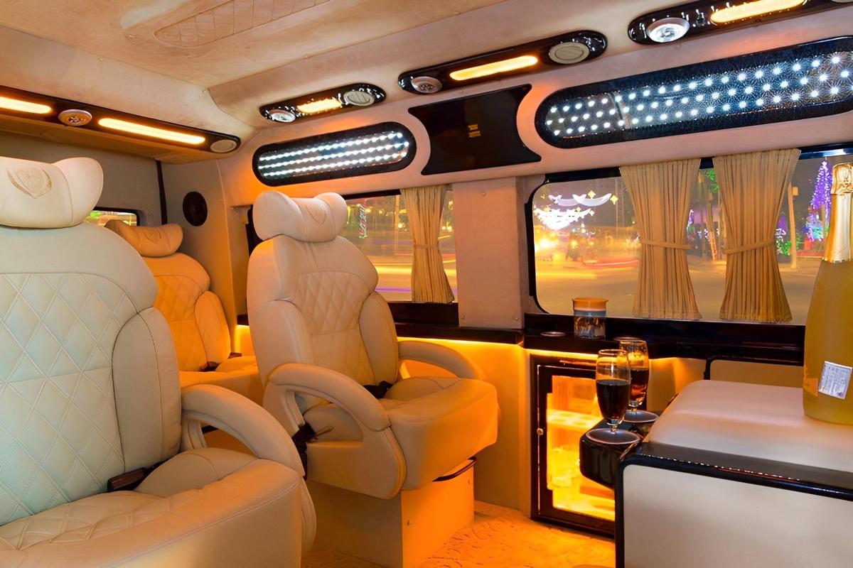 a train car with seats and a table with a glass of wine