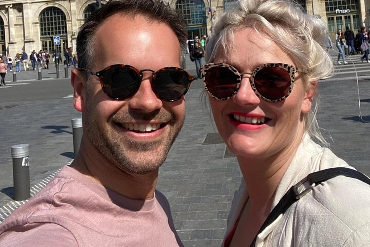 a man and a woman wearing sunglasses posing for a picture