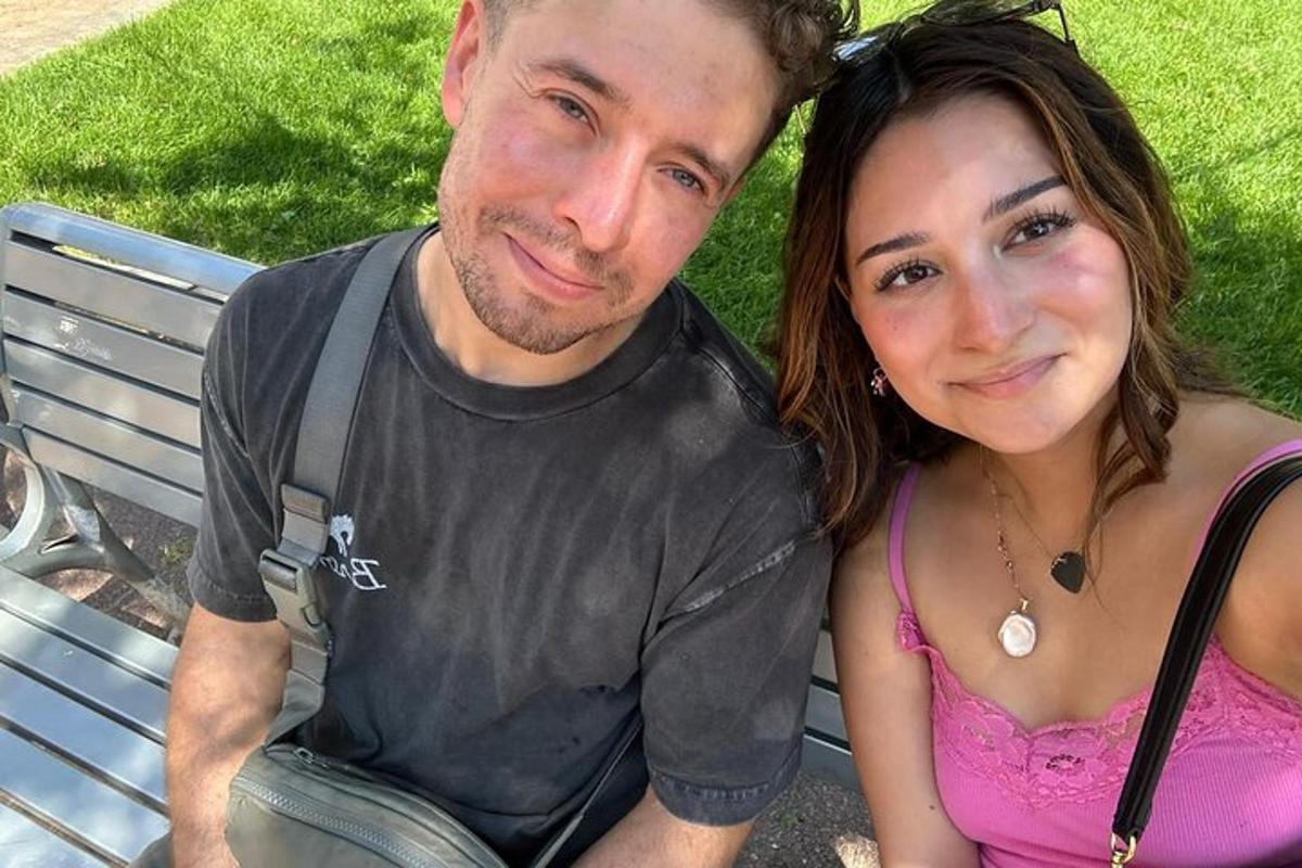 a man and a woman sitting on a bench